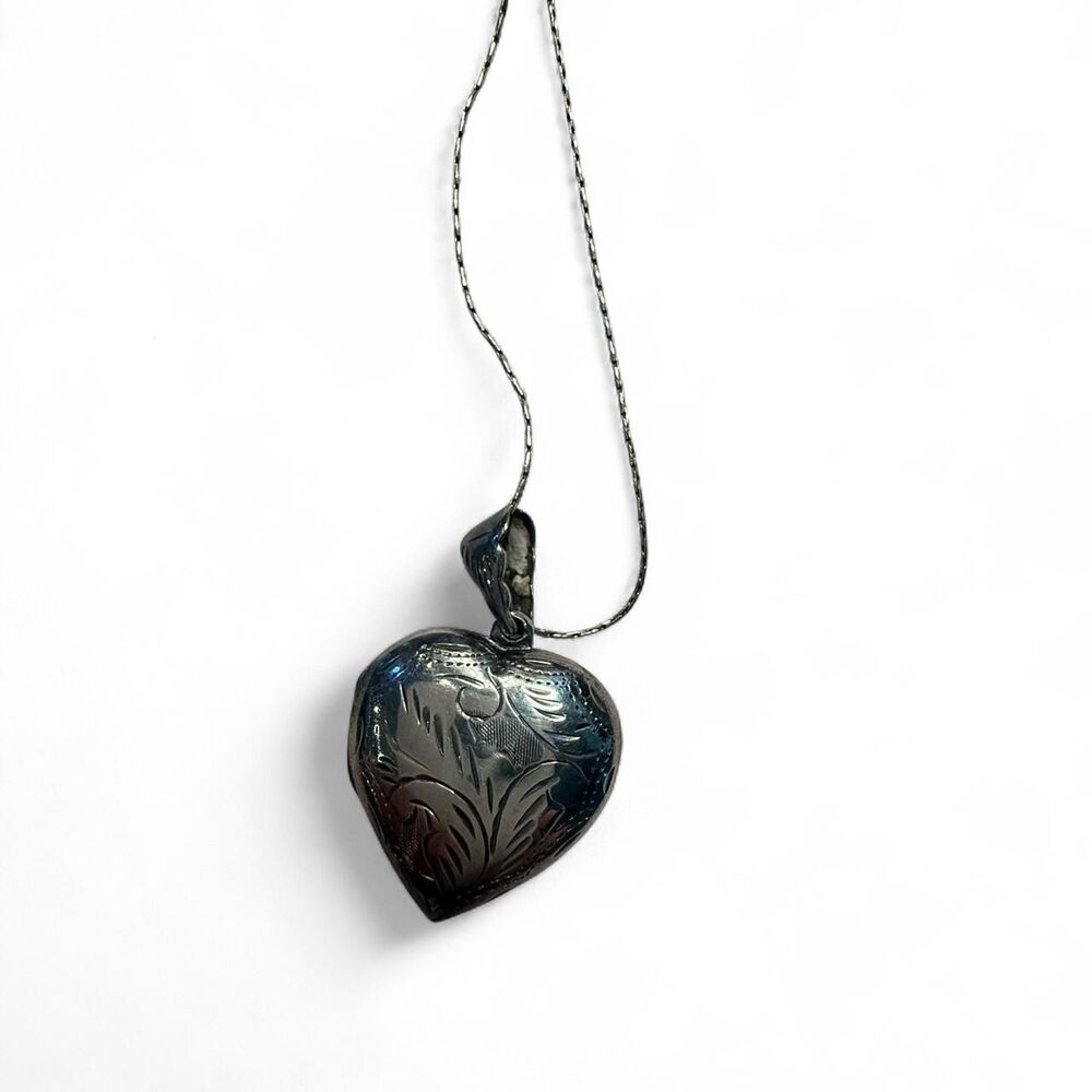 Vintage sterling silver heart locket with engraved floral design